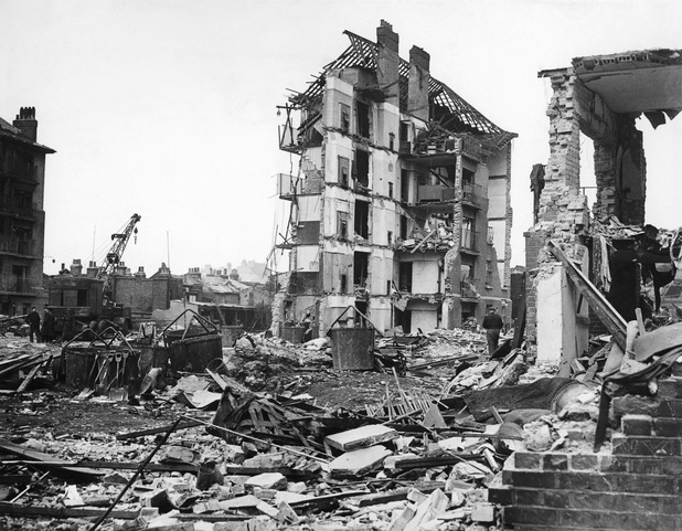 Black and white picture of a ruined building amongst rubble at Whitechapel