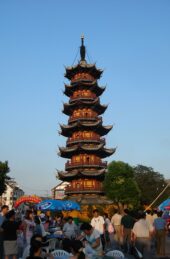 Photograph of the exterior of Longhua Pagoda against a blue sky.