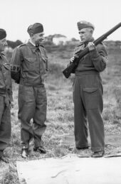 Local Defence Volunteers: A sergeant instructor explaining the working of a rifle to two members of the Local Defence Volunteers at Bisley range.