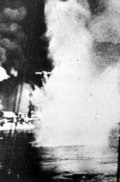 Black and white photograph of Bretagne on fire and under bombardment, taken in 1940.