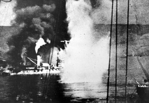 Black and white photograph of Bretagne on fire and under bombardment, taken in 1940.